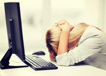 business, office, school and education concept - stressed businesswoman with computer at work