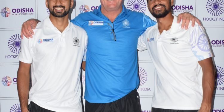 Coach of the Indian hockey team Graham Reid poses with skipper Manpreet Singh and vice-captain Birendra Lakra (L)