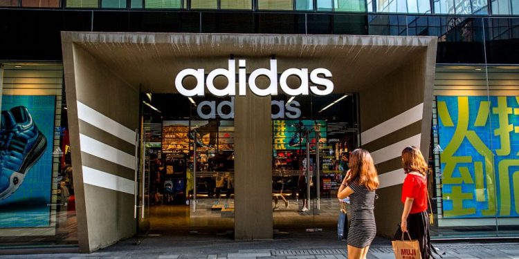 SANLITUN, BEIJING, CHINA - 2015/08/08: An Adidas shop in Sanlitun.  Adidas, the world's second-largest sportswear maker, reported in early August that its second-quarter sales in Greater China were up 19.3 %. (Photo by Zhang Peng/LightRocket via Getty Images)