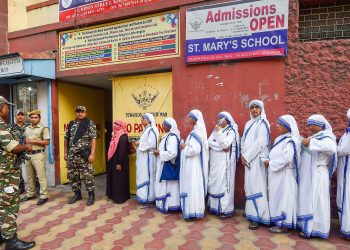 Nuns line up to cast their votes Sunday amid tight security at a polling booth in Kolkata