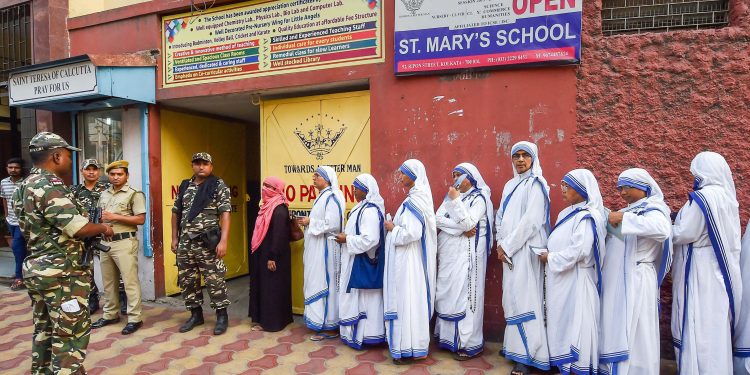 Nuns line up to cast their votes Sunday amid tight security at a polling booth in Kolkata