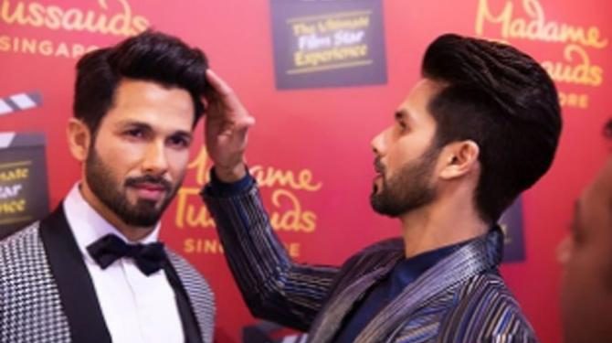 Shahid poses with his wax statue in Singapore