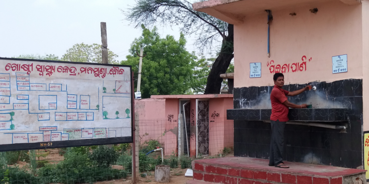 The defunct water project. An attendant opens a tap only to find that it does not work anymore