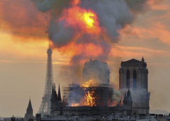 In this image made available on Tuesday April 16, 2019 flames and smoke rise from the blaze at Notre Dame cathedral in Paris, Monday, April 15, 2019. An inferno that raged through Notre Dame Cathedral for more than 12 hours destroyed its spire and its roof but spared its twin medieval bell towers, and a frantic rescue effort saved the monument's "most precious treasures," including the Crown of Thorns purportedly worn by Jesus, officials said Tuesday. (AP Photo/Thierry Mallet)