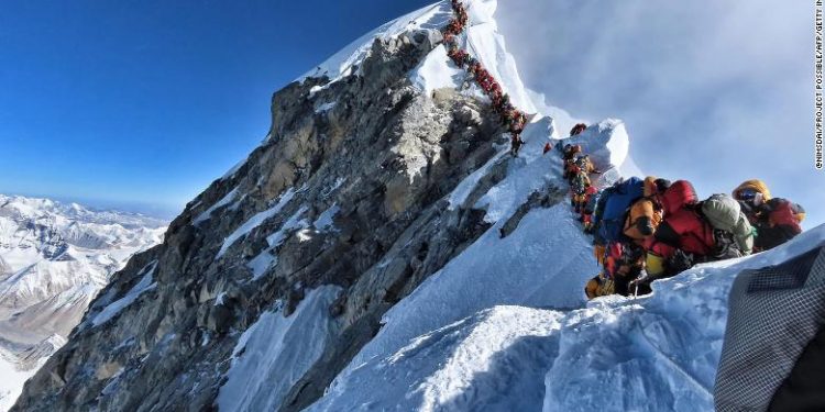 TOPSHOT - This handout photo taken on May 22, 2019 and released by climber Nirmal Purja's Project Possible expedition shows heavy traffic of mountain climbers lining up to stand at the summit of Mount Everest. - Many teams had to line up for hours on May 22 to reach the summit, risking frostbites and altitude sickness, as a rush of climbers marked one of the busiest days on the world's highest mountain. (Photo by Handout / Project Possible / AFP) / RESTRICTED TO EDITORIAL USE - MANDATORY CREDIT "AFP PHOTO / PROJECT POSSIBLE" - NO MARKETING NO ADVERTISING CAMPAIGNS - DISTRIBUTED AS A SERVICE TO CLIENTS ---HANDOUT/AFP/Getty Images