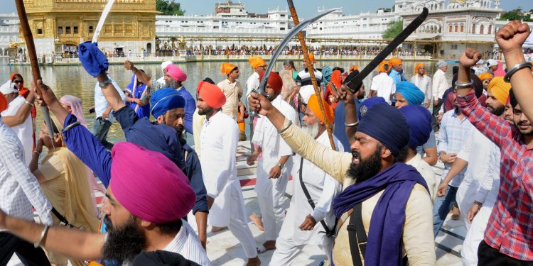 Amritsar: Members of various radical Sikh organizations shout pro-Khalistan slogans and brandish swords at a demonstration marking the 35th anniversary of the Operation Blue Star, 1984, at Golden Temple in Amritsar, Thursday, June 6, 2019. (PTI Photo)  (PTI6_6_2019_000049B) *** Local Caption ***