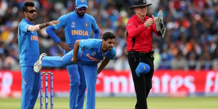 Bhuvneshwar Kumar stretches after suffering a hamstring niggle during the game against Pakistan