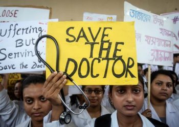 A doctor holds a placard at a government hospital during a strike demanding security after the recent assaults on doctors by the patients' relatives, in Agartala, India, June 14, 2019. REUTERS/Jayanta Dey
