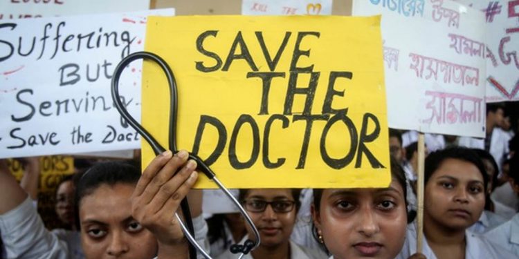 A doctor holds a placard at a government hospital during a strike demanding security after the recent assaults on doctors by the patients' relatives, in Agartala, India, June 14, 2019. REUTERS/Jayanta Dey