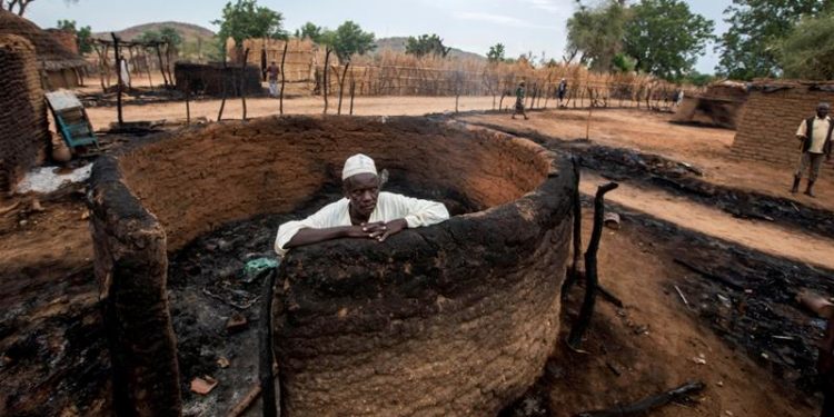 A man inside his burnt house in central Darfur. (Image: Reuters)