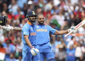 Shikhar Dhawan celebrates after reaching his hundred against Australi as Virat Kohli looks on