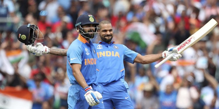 Shikhar Dhawan celebrates after reaching his hundred against Australi as Virat Kohli looks on