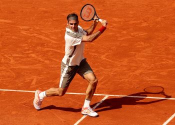 Roger Federer plays a backhand during his match at Roland Garros