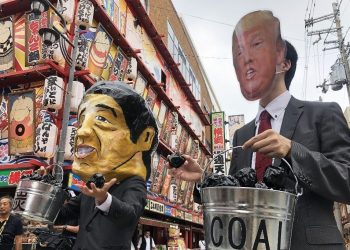 Protesters wearing masks of world leaders including a giant paper mache Japanese Prime Minister Shinzo Abe (L) and US President Donald Trump demonstrate against climate change and coal use, at Osaka in Japan