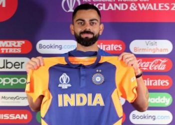 Virat Kohli with the orange jersey. PTI