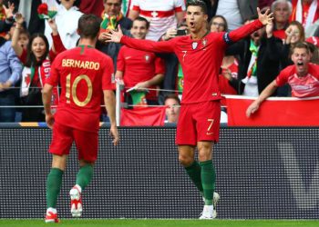 Cristiano Ronaldo (7) celebrates with a teammate after scoring a goal against Switzerland, Wednesday