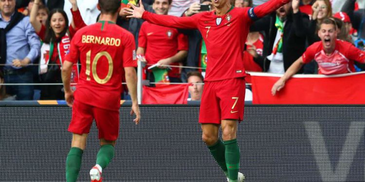 Cristiano Ronaldo (7) celebrates with a teammate after scoring a goal against Switzerland, Wednesday