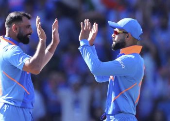 Mohammed Shami (L) celebrates with skipper Virat Kohli after dismissing a West Indian batsman, Thursday