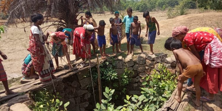 Tribals drink muddy water from open well