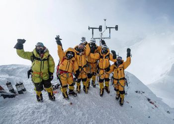 The installation team pose for a photo.