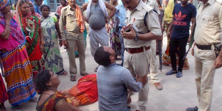 Relatives of the victims of a mob lynching incident mourn outside a hospital in Chapra in Bihar, Friday