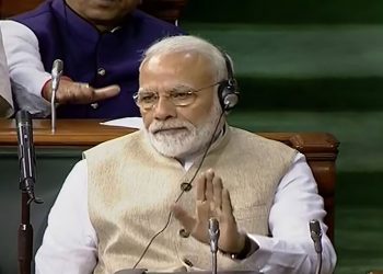 Narendra Modi listens during the presentation of the Union Budget in Lok Sabha