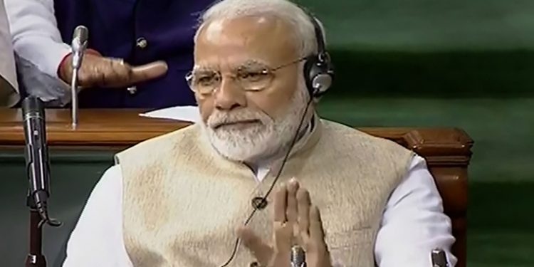 Narendra Modi listens during the presentation of the Union Budget in Lok Sabha