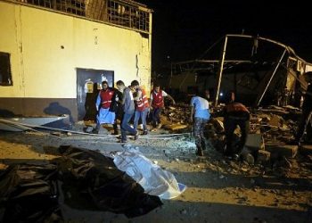 Emergency workers and other recover bodies after an airstrike killed nearly 40 at Tajoura Detention Center, east of Tripoli early July 3, 2019. (Photo by AFP)