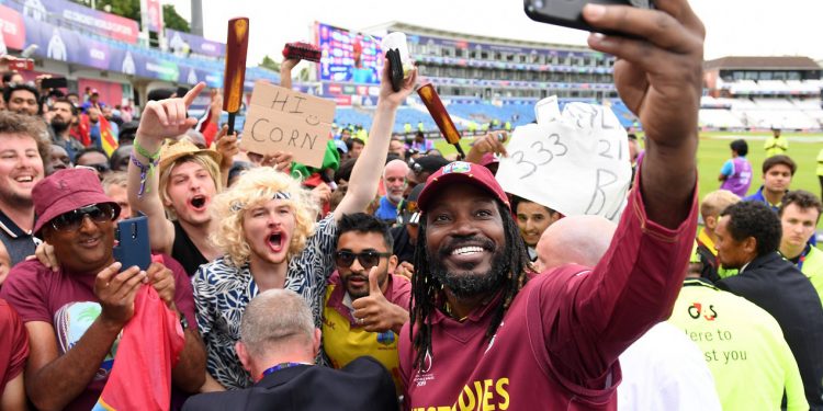 Chris Gayle takes a selfie with fans after the game Thursday