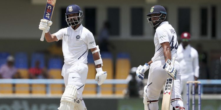 Ajinkya Rahane raises his bat after his century against the West Indies, Sunday
