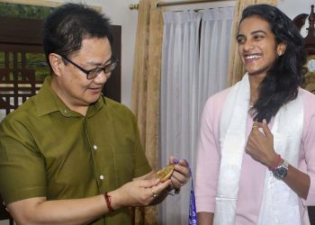 PV Sindhu shows her World Championships gold medal to Sports Minister Kiren Rijiju at New Delhi, Tuesday