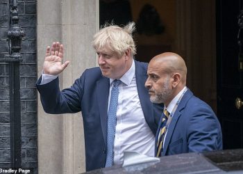 UK Prime Minister Boris Johnson (L) with an aide