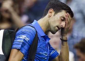 A disappointed Novak Djokovic walks off the court at the US Open, Sunday