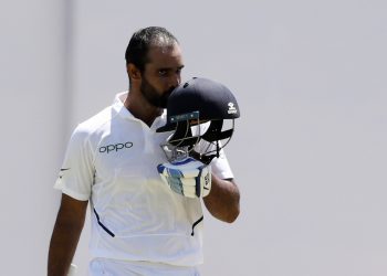 Hanuma Vihari kisses the Tricolour on his helmet after getting his first Test hundred against the West Indies