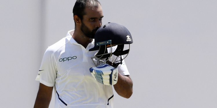 Hanuma Vihari kisses the Tricolour on his helmet after getting his first Test hundred against the West Indies