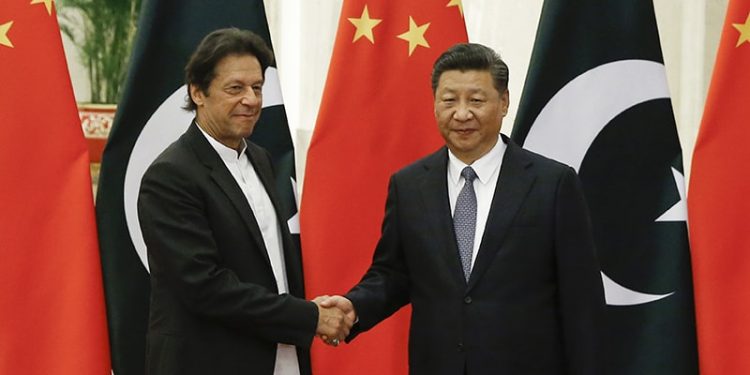 China's President Xi Jinping, right, meets Pakistan's Prime Minister Imran Khan at the Great Hall of the People in Beijing, Friday, Nov. 2, 2018. (Thomas Peter/Pool Photo via AP)