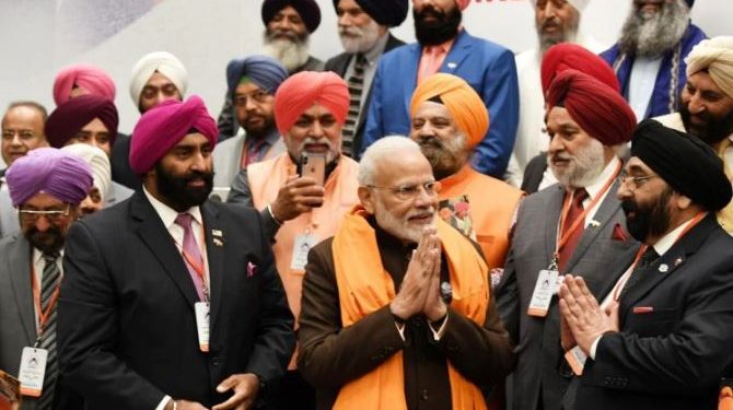 The community members met Modi Saturday in Houston and presented him with a traditional Siropa (long scarf).