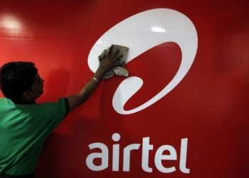 A worker cleans a Bharti Airtel logo inside its shop in Kolkata February 2, 2011.REUTERS/Rupak De Chowdhuri/File Photo