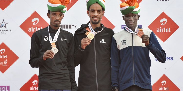 New Delhi: Gold medal winner Ethiopia's Andamlak Belihu, flanked by silver medallist compatriot Solomon Berihu (L) and bronze medallist Kenneth Kibiwott Kandie (R) of Kenya