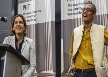 Esther Duflo (L) and Abhijit Banerjee speak during a news conference at Massachusetts Institute of Technology, Monday