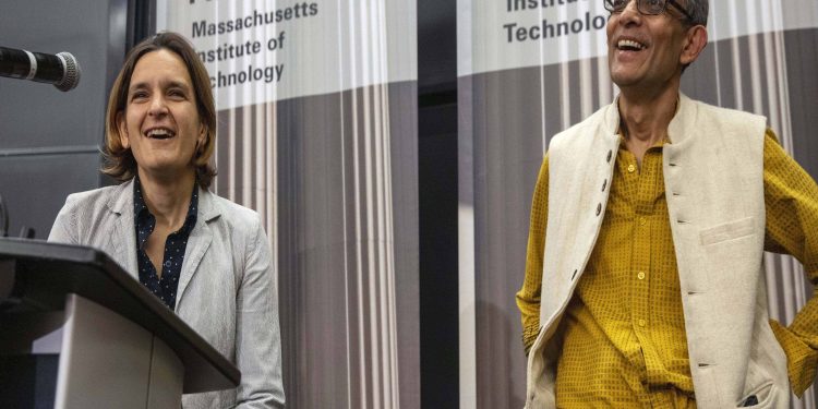 Esther Duflo (L) and Abhijit Banerjee speak during a news conference at Massachusetts Institute of Technology, Monday