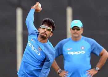 Indian cricketer Yuzvendra Chahal (L) delivers a ball as coach Ravi Shastri looks on during a practice session at the Rangiri Dambulla International Cricket Stadium in Dambulla on August 18, 2017. 
The one day international cricket series between India and Sri Lanka starts in Dambulla on August 20. / AFP PHOTO / LAKRUWAN WANNIARACHCHI        (Photo credit should read LAKRUWAN WANNIARACHCHI/AFP/Getty Images)