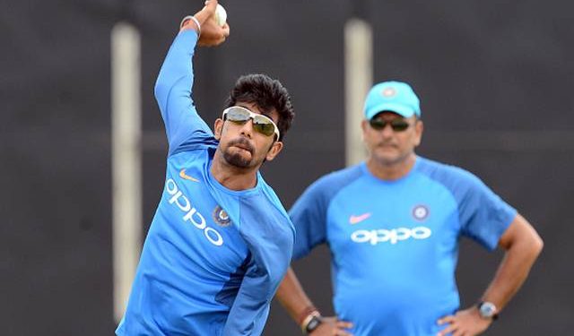 Indian cricketer Yuzvendra Chahal (L) delivers a ball as coach Ravi Shastri looks on during a practice session at the Rangiri Dambulla International Cricket Stadium in Dambulla on August 18, 2017. 
The one day international cricket series between India and Sri Lanka starts in Dambulla on August 20. / AFP PHOTO / LAKRUWAN WANNIARACHCHI        (Photo credit should read LAKRUWAN WANNIARACHCHI/AFP/Getty Images)