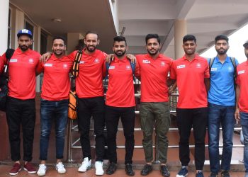 Manpreet Singh (C) and other members of the Indian hockey team pose at the BPIA upon their arrival, Monday