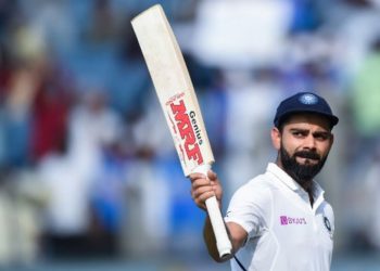 India's cricket team captain Virat Kohli rises his bat as he leaves the field after declearing their first innings during the second day of the second Test cricket match between India and South Africa at Maharashtra Cricket Association Stadium in Pune on October 11, 2019. (Photo by Punit PARANJPE / AFP) / IMAGE RESTRICTED TO EDITORIAL USE - STRICTLY NO COMMERCIAL USE