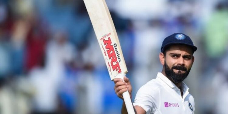 India's cricket team captain Virat Kohli rises his bat as he leaves the field after declearing their first innings during the second day of the second Test cricket match between India and South Africa at Maharashtra Cricket Association Stadium in Pune on October 11, 2019. (Photo by Punit PARANJPE / AFP) / IMAGE RESTRICTED TO EDITORIAL USE - STRICTLY NO COMMERCIAL USE