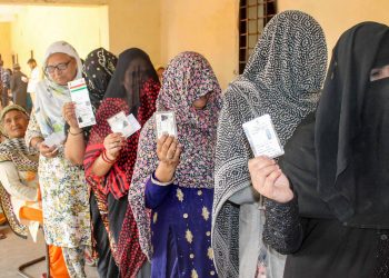 Women voters queue up at a polling booth in Faridabad