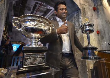 Leander Paes poses with the Australian Open trophy during a promotional event in Mumbai, Tuesday