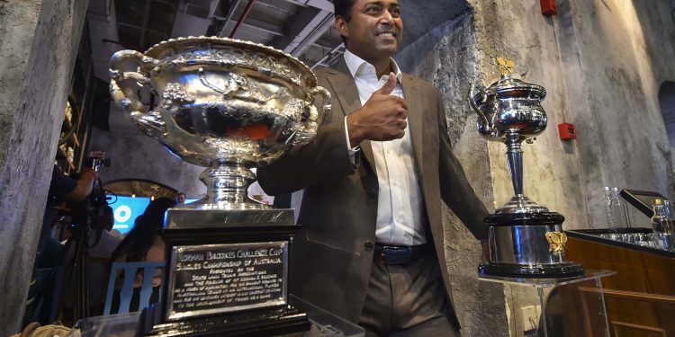Leander Paes poses with the Australian Open trophy during a promotional event in Mumbai, Tuesday