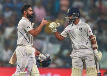 Virat Kohli and teammate Ajinkya Rahane return to the dressing room at the end of the first day against Bangladesh, at Eden Gardens in Kolkata, Friday